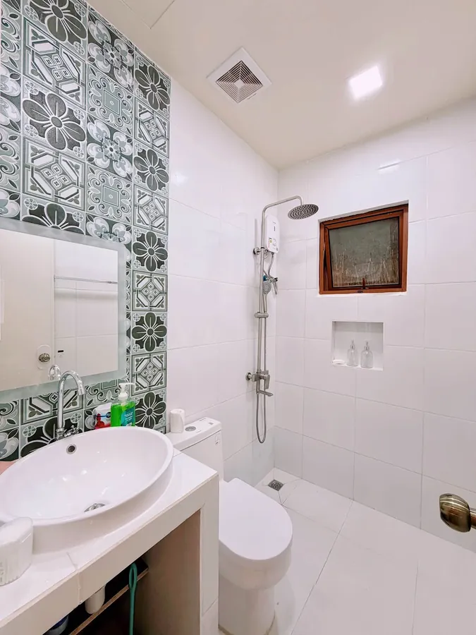 Bathroom with a shower and patterned tiles