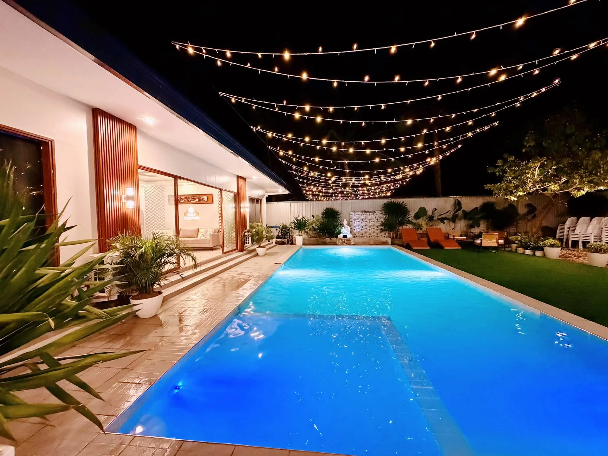 The pool under string lights in the evening