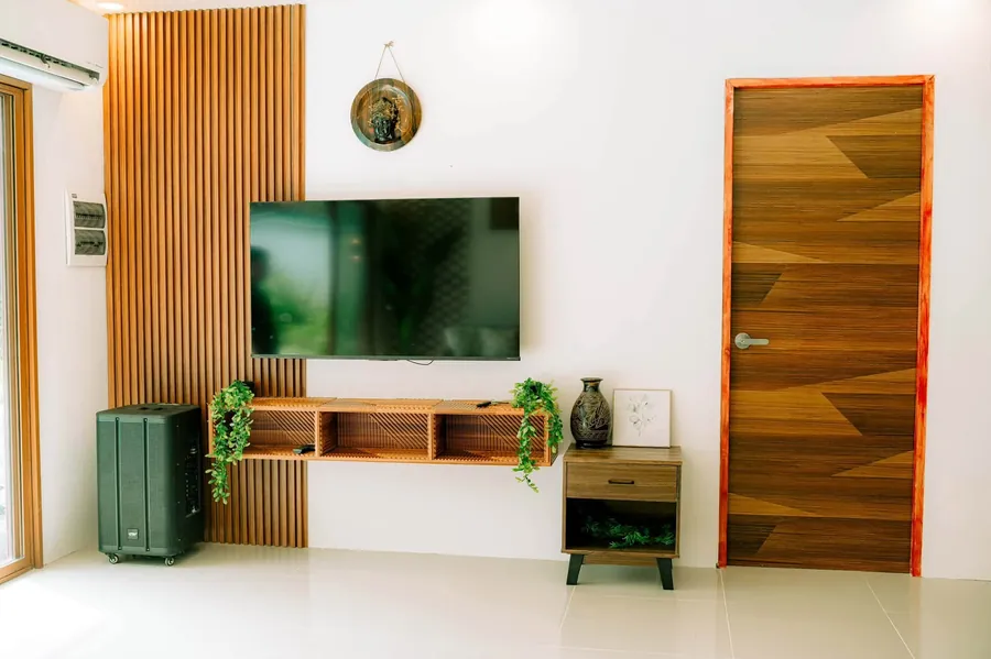 TV wall with wood slats and a floating shelf