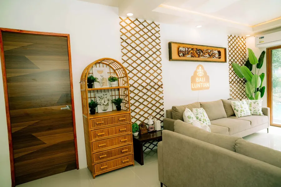 Living room corner with a rattan shelf and plants