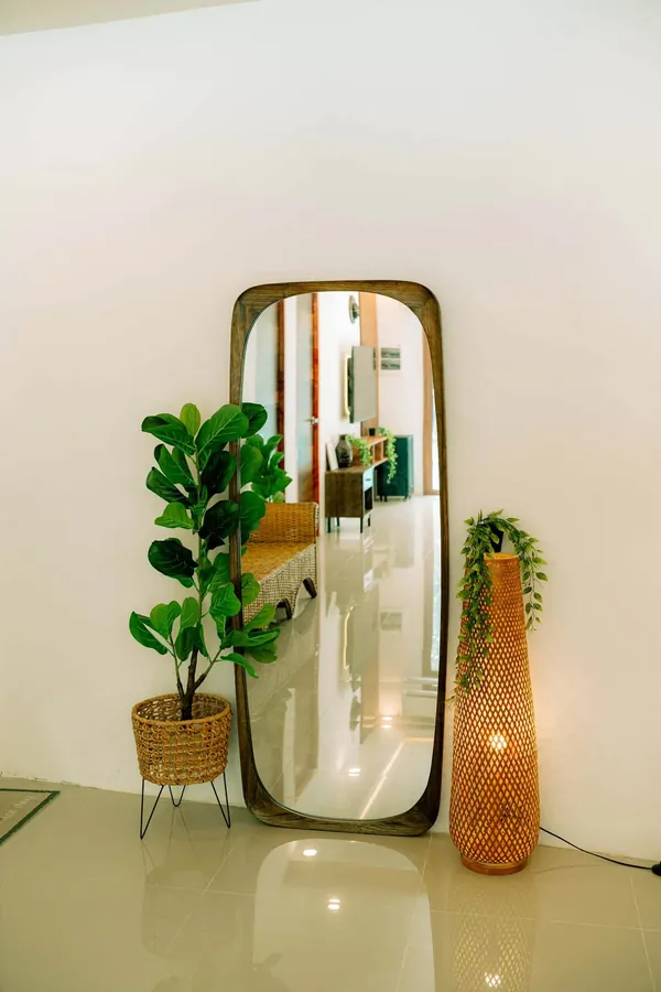 Wood mirror and a woven floor lamp