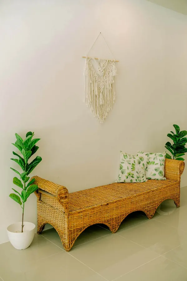 Rattan bench with leaf-print cushions
