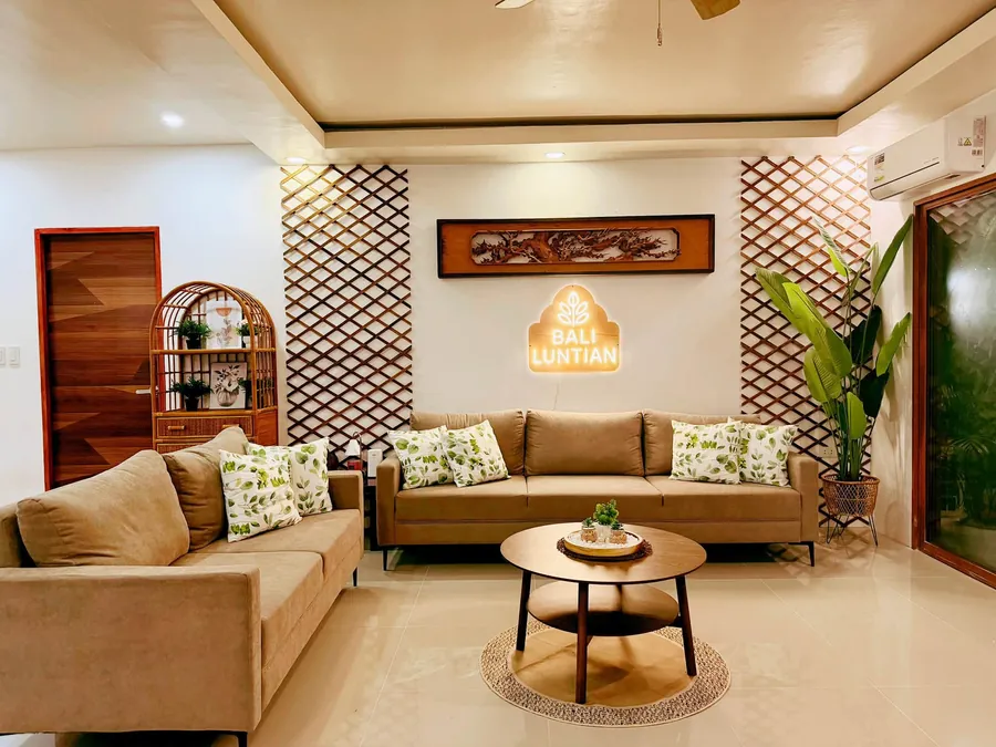 Sofas facing the lit Bhali Lhuntian sign